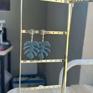 Green monstera leaf clay earrings. With gold bamboo stick stems.